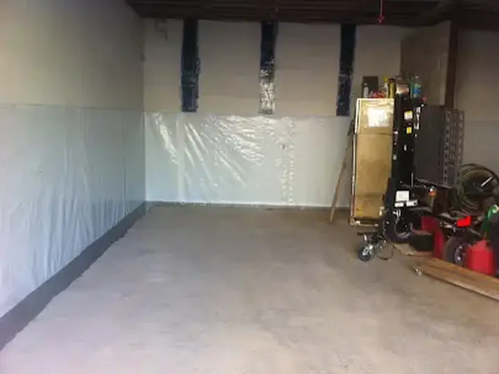Basement under plastic containment with drying equipment in Woodstock, GA
