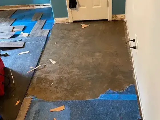 Wet flooring pulled up during a water damage dry-out in Woodstock