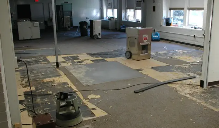 Commercial space with flooring removed and a dehumidifier running in Woodstock