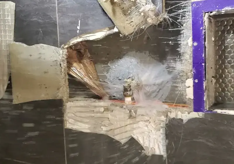 Water spraying from a burst supply pipe in a Woodstock, GA home