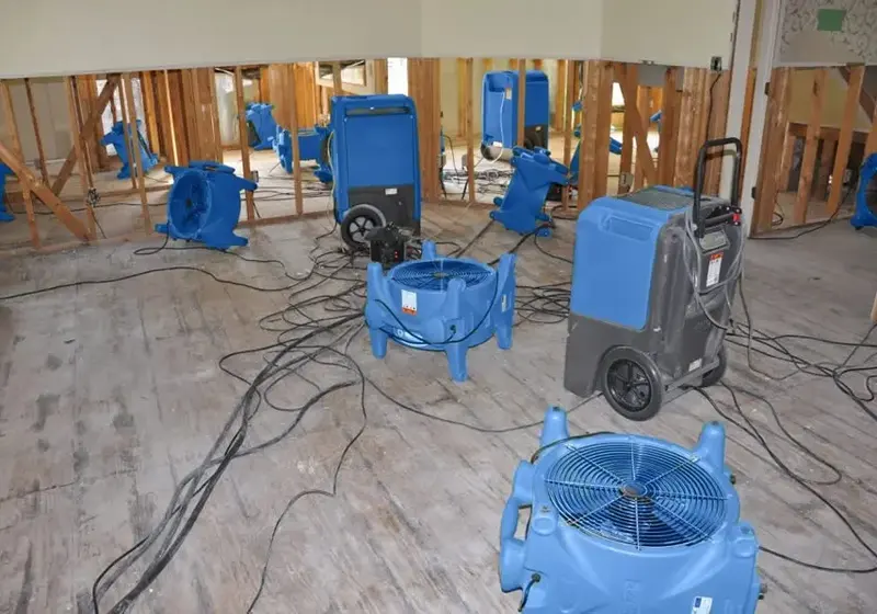 Air movers and a dehumidifier drying a room in Woodstock, GA